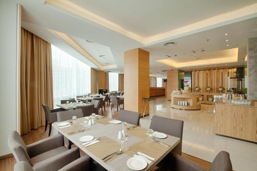 a dining room with tables and chairs and a restaurant at WP Hotel in Kuala Lumpur