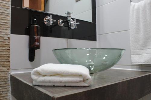 a bathroom with a bowl sink and towels on a counter at Concha y Toro 33 Hotel Boutique by Nobile in Santiago