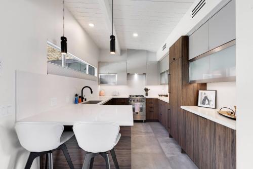 a kitchen with a white counter and white stools at Condo 606 W Arenas Rd Unit 2 Palm Springs in Palm Springs