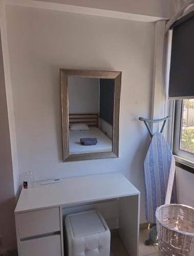 a mirror on the wall of a room with a desk at The Heart of the City in Limassol