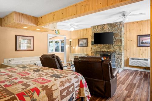 a bedroom with a bed and a fireplace at Carr's Northside Hotel and Cottages in Gatlinburg