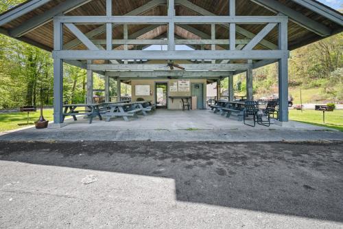 a pavilion with picnic tables and benches in a park at Carr's Northside Hotel and Cottages in Gatlinburg