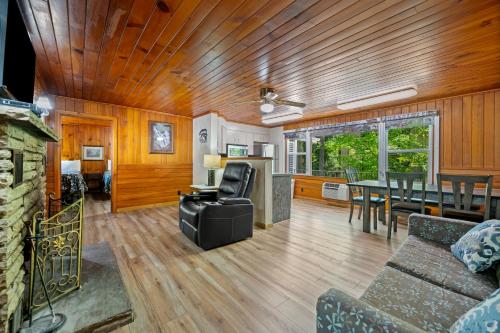 a living room with a couch and a table at Carr's Northside Hotel and Cottages in Gatlinburg