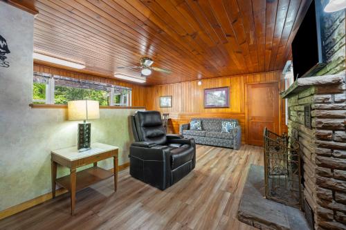 a living room with a chair and a couch at Carr's Northside Hotel and Cottages in Gatlinburg