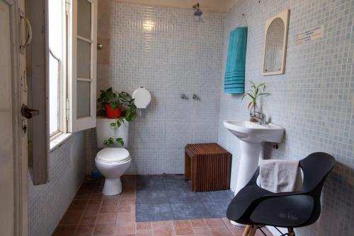 a bathroom with a white toilet and a sink at IDEAL CENTER in Buenos Aires