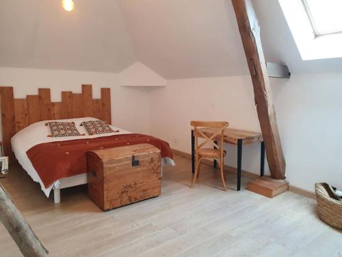 a bedroom with a bed and a table and a chair at Maison campagne spacieuse in Degré