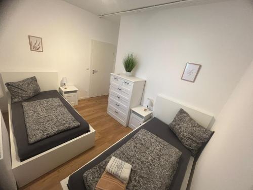 a small bedroom with a bed and a dresser at Altstadt Hemsbach in Hemsbach