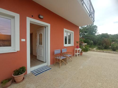 a house with a patio with a table and chairs at Apartment Nada in Izola