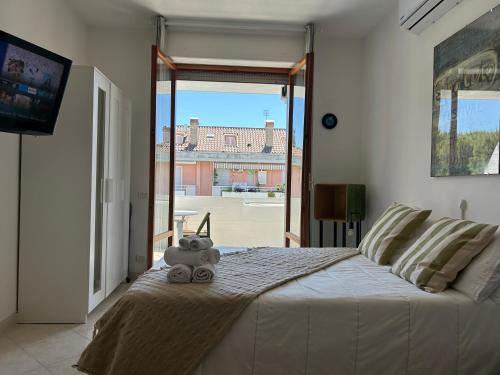 a teddy bear sitting on a bed in a bedroom at Bomboniera a due passi dal mare-FH in San Benedetto del Tronto