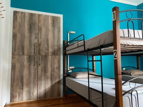 a bunk bed room with two bunk beds and a door at Lait Hostel in Ioannina