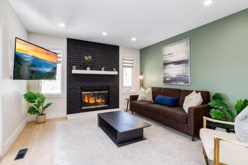 a living room with a couch and a fireplace at Pet Friendly & Accessible, 4 Beds in Calgary