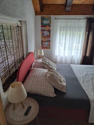 a bedroom with a large bed and a window at Apartman Batarelo in Gornji Karin