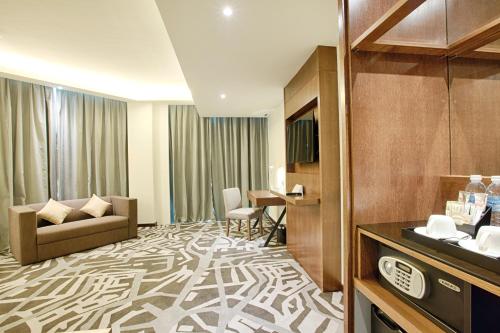 a hotel room with a couch and a table at WP Hotel in Kuala Lumpur