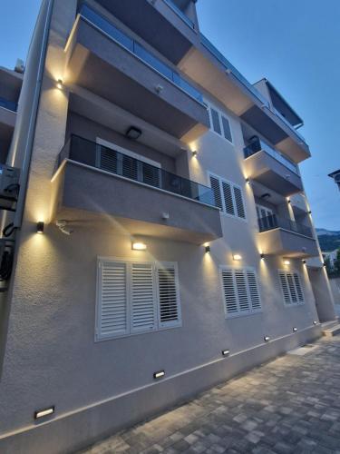 a white building with lights on the side of it at House Villa Roza in Tučepi