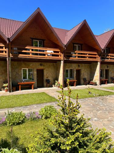 a large house with a wooden roof at Kipreya in Yaremche