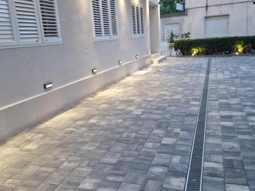 an empty sidewalk in front of a building at House Villa Roza in Tučepi