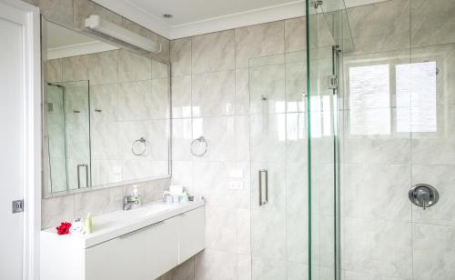 a bathroom with a shower and a sink at Paradise Hotel & Resort in Burnt Pine