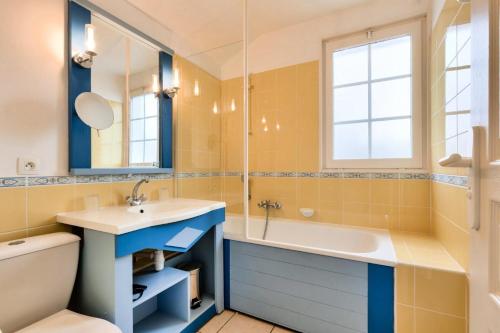 une salle de bain avec un lavabo, une baignoire et des toilettes dans l'établissement Les Maisons de Port Bourgenay - maeva Home - Maison cosy 3 pièces 8 personnes - Prestige - super Home MAE-7094, à Talmont-Saint-Hilaire