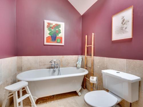 a bathroom with a white tub and a toilet at 1 Bed in Gillamoor G0029 in Gillamoor