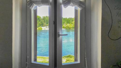 une fenêtre ouverte avec vue sur l'eau dans l'établissement B&B Osteria dello sperone, à Lonate Pozzolo