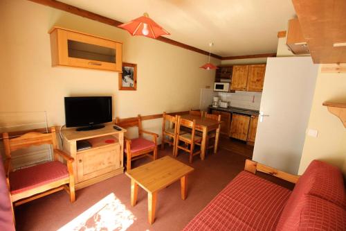 a living room with a kitchen and a dining room at Chalets Du Thabor - 2 Pièces pour 4 Personnes 82 in Modane