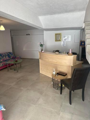 a room with a counter and a chair and a table at Pansion Angela in Skiathos Town