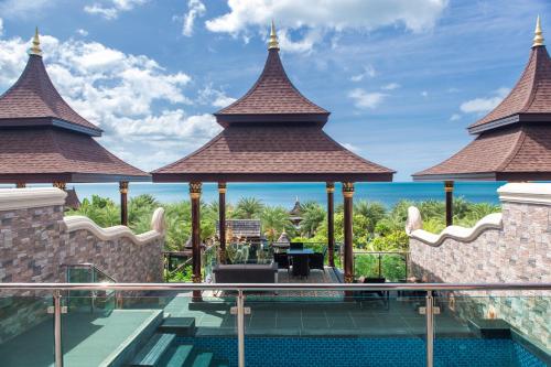 a resort swimming pool with a view of the ocean at Ammatara Pura Pool Villa in Lamai