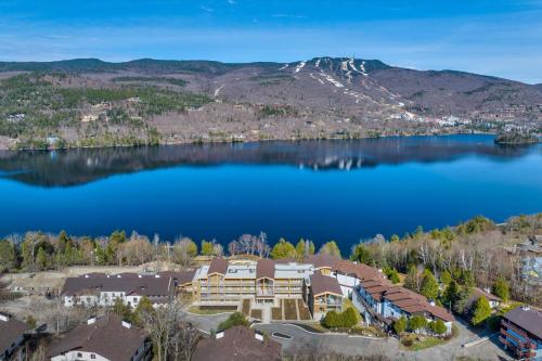 an aerial view of a house on the shore of a lake at Lago by Tremblant Platinum in Mont-Tremblant