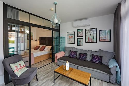 a living room with a couch and a bed at APARTMENT FLAMINGO in Playa del Ingles