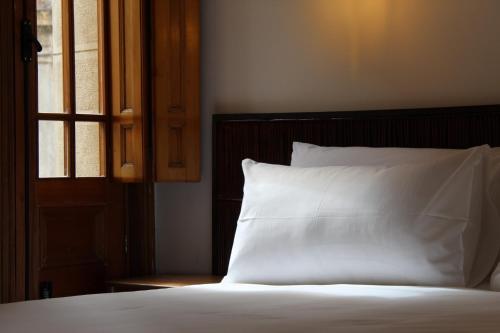 Säng eller sängar i ett rum på Concha y Toro 33 Hotel Boutique by Nobile