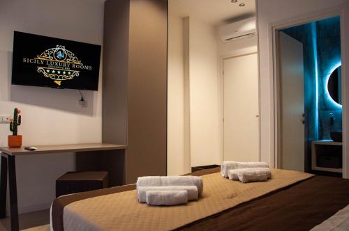een slaapkamer met 2 handdoeken op een bed bij Sicily Luxury Rooms in Palermo