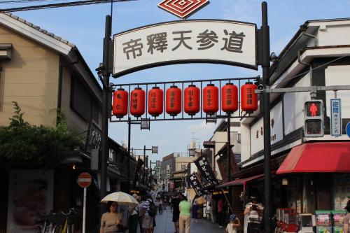 a street in an asian city with red lantern signs at Hostel Hana An in Tokyo