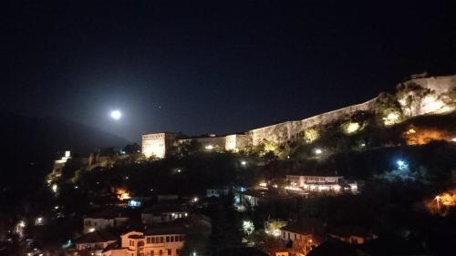 a castle on top of a hill at night at Guesthouse Çelo in Gjirokastër