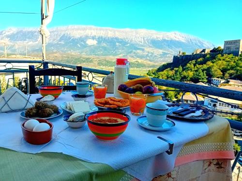 a table with food on it with mountains in the background at Guesthouse Çelo in Gjirokastër