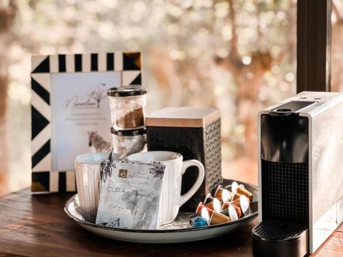 a tray with cups and other items on a table at Maroelani Lodge- Greater Kruger Private Reserve in Hoedspruit