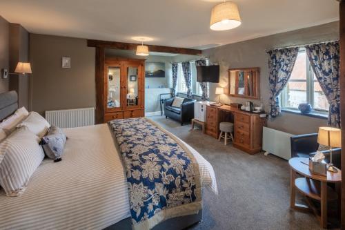 a bedroom with a bed and a living room at East Hook Farmhouse in Haverfordwest