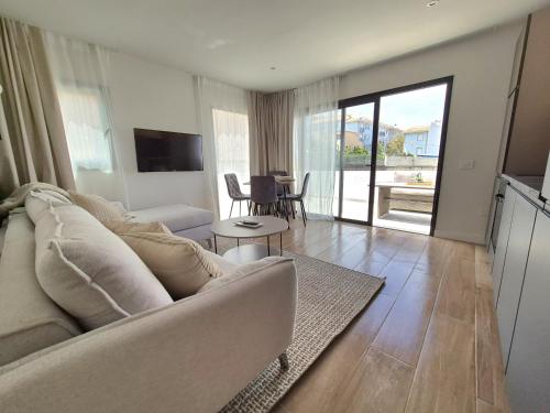 a living room with a white couch and a table at 5 Dragos Suites in La Orotava
