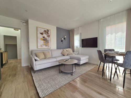 a living room with a couch and a table at 5 Dragos Suites in La Orotava