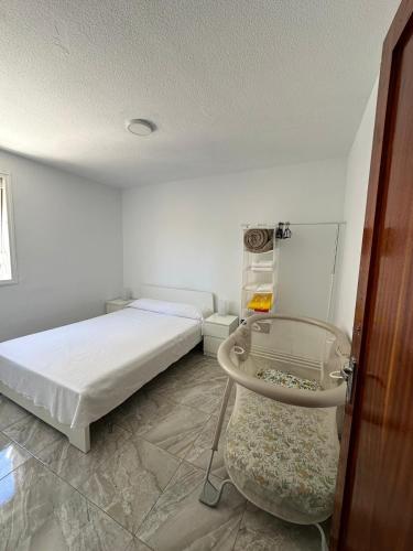 a bedroom with a bed and a glass table at Vivienda en Arrecife de 4 habitaciones in Arrecife