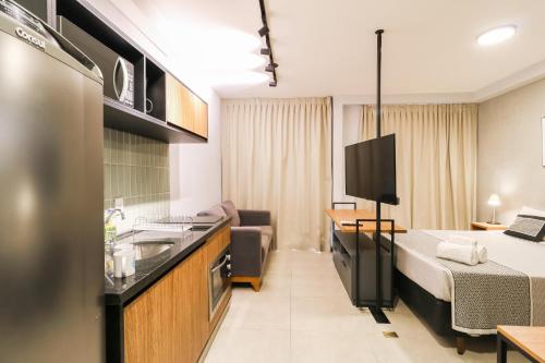 a room with a kitchen and a bed in a room at Meu Club Haas in Sao Paulo