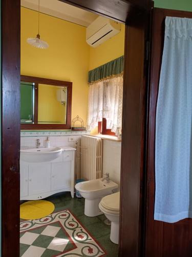 a bathroom with a white toilet and a sink at B&B Maison Brunetti in Boiano