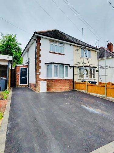 an empty parking lot in front of a house at Newly Renovated En-Suite Private Room in Birmingham Selly Oak R1 in Birmingham