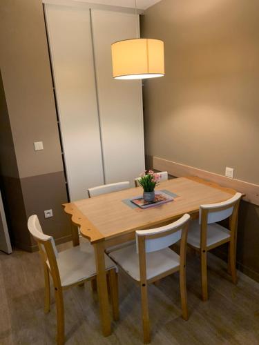 a dining room with a wooden table and chairs at Apartments 4/5P - Disneyland Paris in Serris