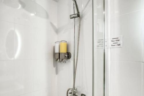 a shower with a yellow candle in a bathroom at COBLANCA 5-STUDIO EXCLUSIVO in Benidorm
