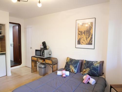 a living room with a couch with stuffed animals on it at Studio centre de Cannes in Cannes