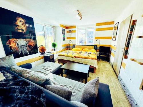 a living room with a couch and a table at Apartmán Pod hradem in Horšovský Týn