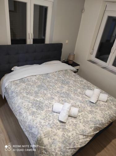 a bedroom with a bed with two towels on it at Kalipso home in Mytilene