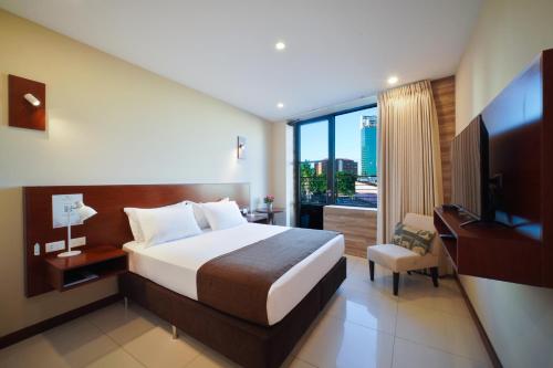 a hotel room with a bed and a large window at Chairu Eco Hotel in Santa Cruz de la Sierra
