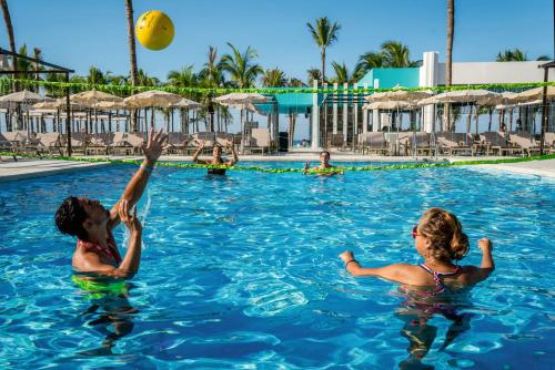 two women playing with a beach ball in the swimming pool at Riu Vallarta - All Inclusive in Bucerías