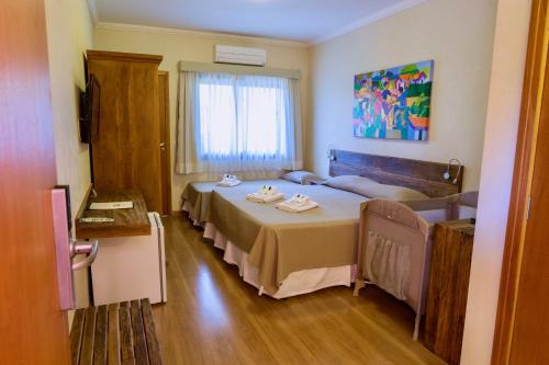a room with a bed and a couch in it at Hotel Fazenda Santa Monica in Louveira